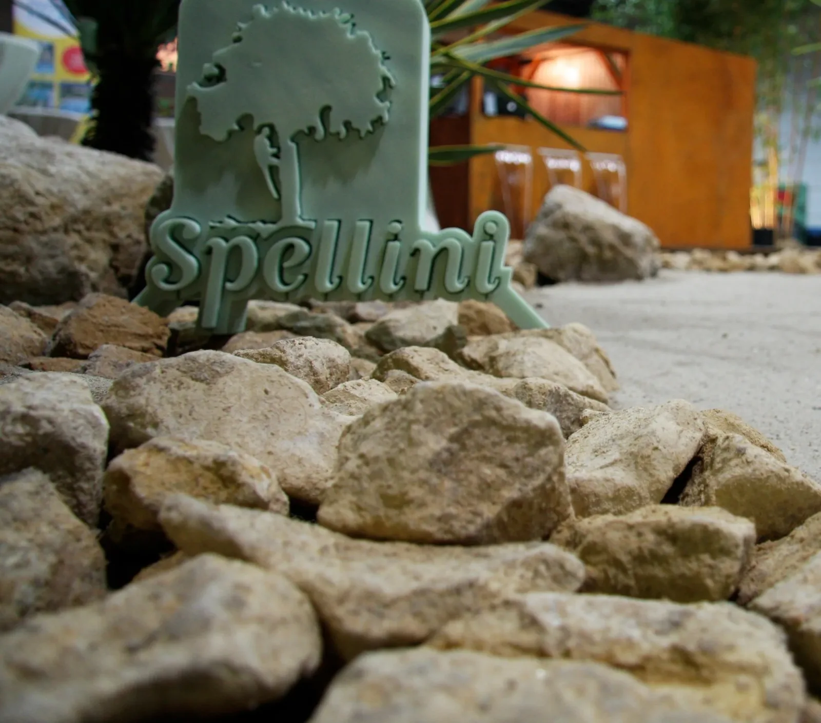 The cut Spellini sign, set in a bed of stones